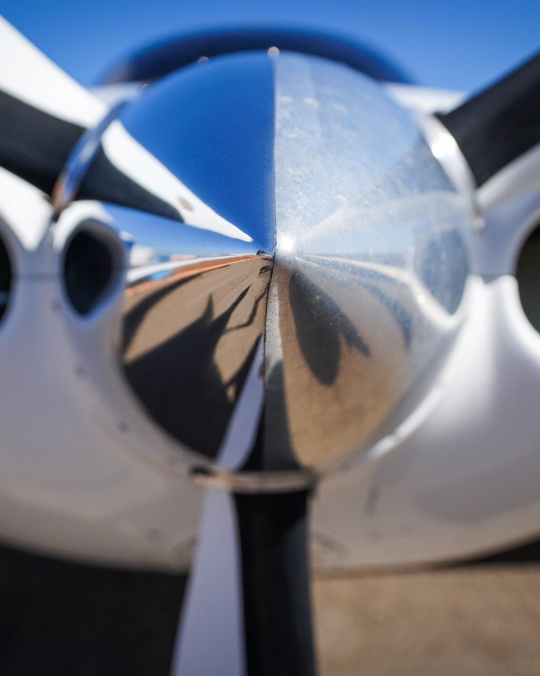 50/50 polished aircraft propeller spinner showing half mirror-polished finish — Fly Shiny aircraft metal polish